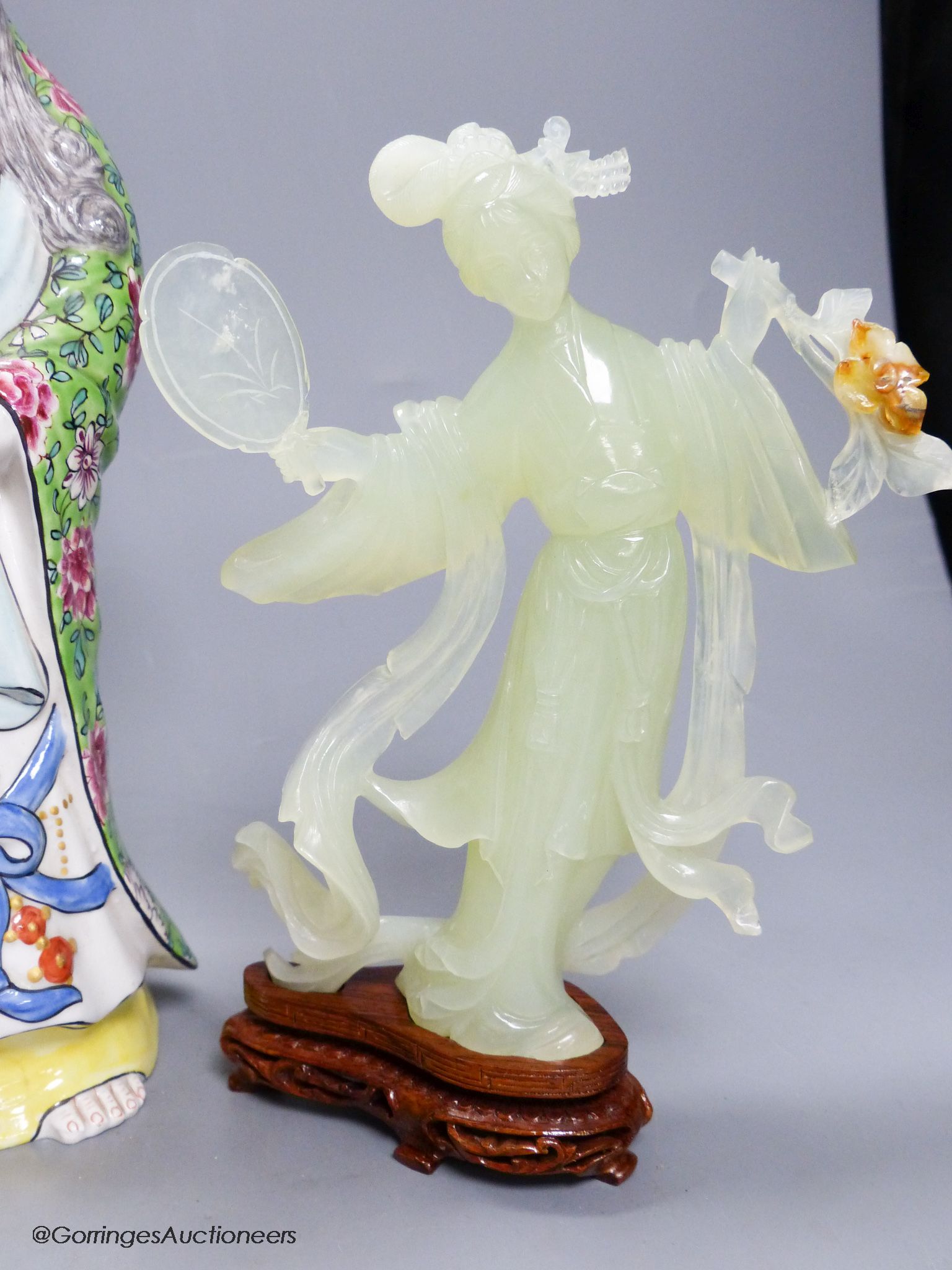 A pair of cased Chinese bowenite jade figure carvings and a porcelain figure of Guanyin, height 33cm